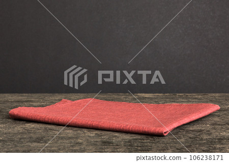top view with red empty kitchen napkin isolated on table background. Folded cloth for mockup with copy space, Flat lay. Minimal style 106238171