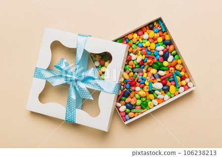 Box with sweet chocolate candies on color background, Various candy sweets. Valentines day gift box. Top view flat lay with copy space 106238213