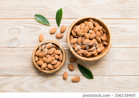 Fresh healthy Almond in bowl on colored table background. Top view 106238405
