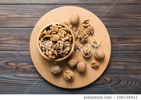 Fresh healthy walnuts in bowl on colored table background. Top view Healthy eating bertholletia concept. Super foods 106238421