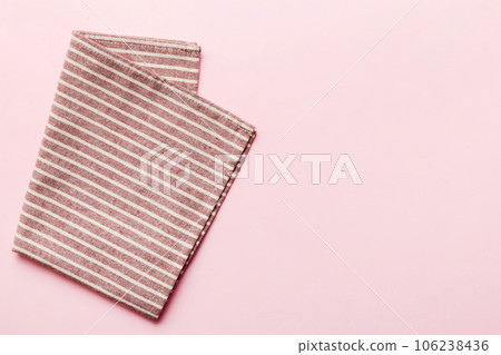 top view with red empty kitchen napkin isolated on table background. Folded cloth for mockup with copy space, Flat lay. Minimal style 106238436