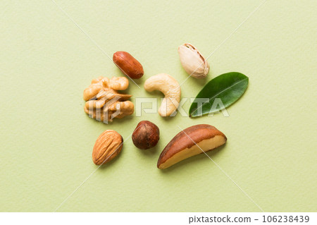 Composition of nuts , flat lay - mix hazelnuts, cashews, almonds on table background. healthy eating concepts and food background 106238439