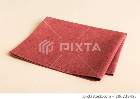 top view with red empty kitchen napkin isolated on table background. Folded cloth for mockup with copy space, Flat lay. Minimal style 106238453