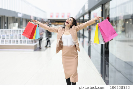 Happy joyful woman with purchases in mall closeup Happy joyful woman with purchases in mall closeup 106238523