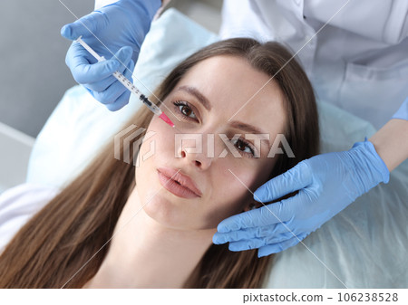 Young woman receiving anti-aging injection in beauty clinic Young woman receiving anti-aging injection in beauty clinic 106238528