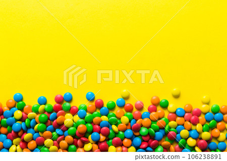 Mixed collection of colorful candy, on colored background. Flat lay, top view. frame of colorful chocolate coated candy Mixed collection of colorful candy, on colored background. Flat lay, top view. frame of colorful chocolate coated candy 106238891