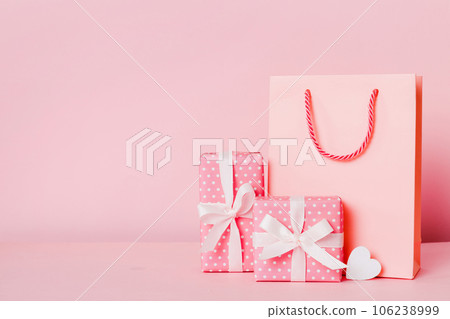Shopping bag with gift box on colored background perspecrive view. Space for text holiday concept Shopping bag with gift box on colored background perspecrive view. Space for text holiday concept 106238999