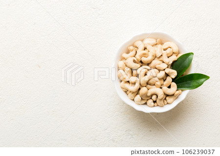 cashew nuts in wooden bowl on table background. top view. Space for text Healthy food cashew nuts in wooden bowl on table background. top view. Space for text Healthy food 106239037