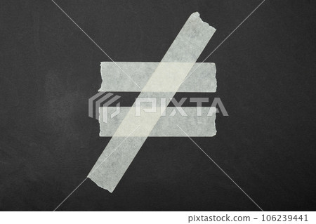 inequality sign close up of an adhesive tape inequality sign close up of an adhesive tape 106239441