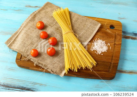 Italian raw spaghetti. Italian cuisine or culinary concept. Selective focus 106239524