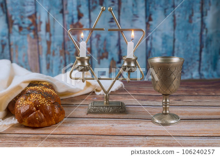 Sabbath warmth traditional jewish holiday celebration with homemade challah bread, kosher wine, candles Sabbath warmth traditional jewish holiday celebration with homemade challah bread, kosher wine, candles 106240257