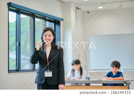 A young cram school teacher doing a guts pose A young cram school teacher doing a guts pose 106240333