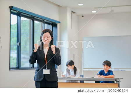 A young cram school teacher doing a guts pose A young cram school teacher doing a guts pose 106240334