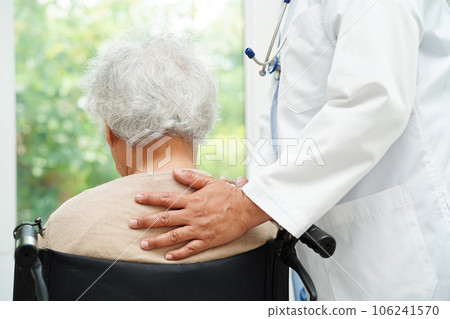 Doctor help Asian elderly woman disability patient sitting on wheelchair in hospital, medical concept. Doctor help Asian elderly woman disability patient sitting on wheelchair in hospital, medical concept. 106241570