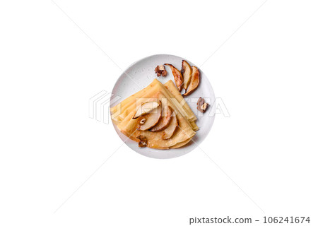 Delicious fresh baked pancakes with honey and fruits on a concrete background 106241674