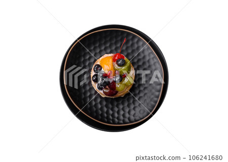 Delicious fresh tart with blueberries, cherries, grapes on a black ceramic plate Delicious fresh tart with blueberries, cherries, grapes on a black ceramic plate 106241680