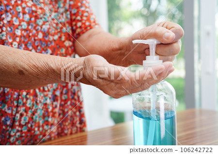 Asian senior woman press blue alcohol sanitizer gel for washing hand protect infection coronavirus. Asian senior woman press blue alcohol sanitizer gel for washing hand protect infection coronavirus. 106242722