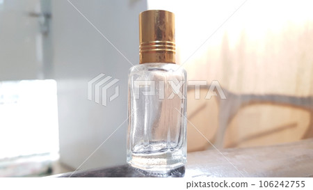 close up view of an empty oud attar oil glass bottle isolated on blurred background close up view of an empty oud attar oil glass bottle isolated on blurred background 106242755