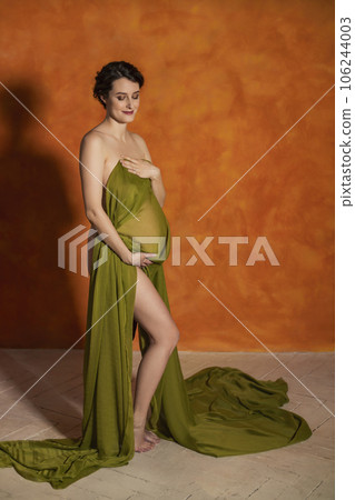 Pregnant woman on orange background 106244003