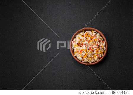 Delicious fresh Asian noodles with pieces of vegetables, meat, with salt, spices and herbs Delicious fresh Asian noodles with pieces of vegetables, meat, with salt, spices and herbs 106244453
