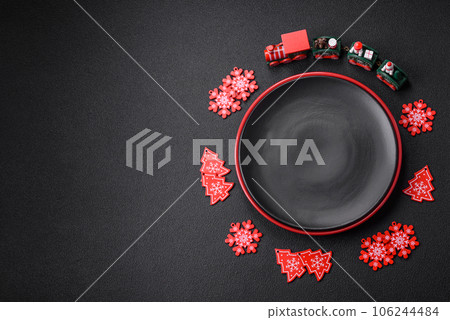 Empty ceramic black plate with christmas decoration elements Empty ceramic black plate with christmas decoration elements 106244484
