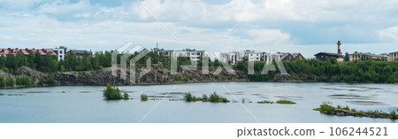 residential buildings on the lakeside of a flooded old quarry 106244521