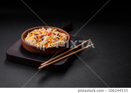 Delicious fresh Asian noodles with pieces of vegetables, meat, with salt, spices and herbs Delicious fresh Asian noodles with pieces of vegetables, meat, with salt, spices and herbs 106244535