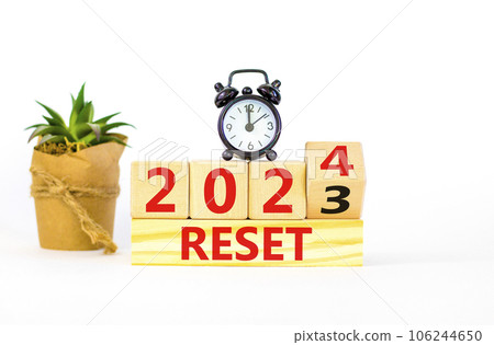 2024 reset new year symbol. Businessman turns a wooden cube and changes words Reset 2023 to Reset 2024. Beautiful white table white background, copy space. Business 2024 reset new year concept. 2024 reset new year symbol. Businessman turns a wooden cube and changes words Reset 2023 to Reset 2024. Beautiful white table white background, copy space. Business 2024 reset new year concept. 106244650