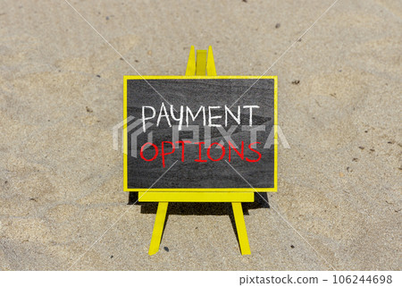 Payment options symbol. Concept words Payment options on beautiful black blackboard. Beautiful sand beach background. Business payment options concept. Copy space. 106244698