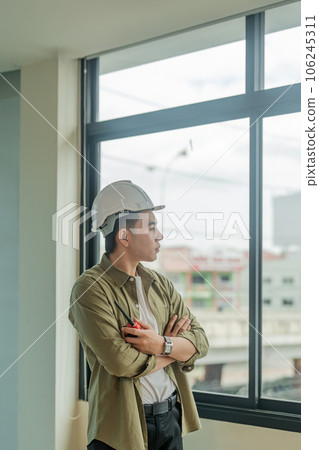 Portrait Asian engineer man working with walkie talkie at construction site Portrait Asian engineer man working with walkie talkie at construction site 106245311