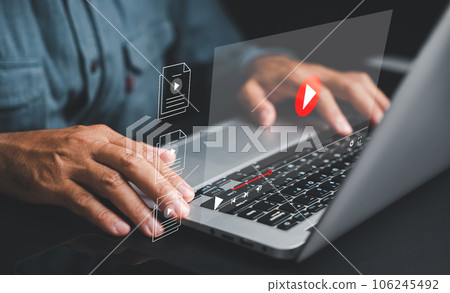 Man using a laptop to stream online videos and tutorials. Watch captivating content on the internet using your mouse and keyboard. Explore a world of digital entertainment and learning. 106245492