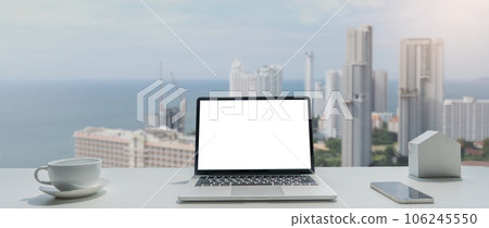 Image of working space by the window equipment in office interior, open laptop computer with mock up screen Image of working space by the window equipment in office interior, open laptop computer with mock up screen 106245550