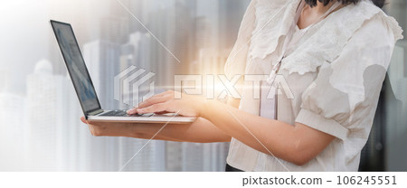 Double exposure image of business communication network technology concept business people using laptop device on modern cityscape background Double exposure image of business communication network technology concept business people using laptop device on modern cityscape background 106245551