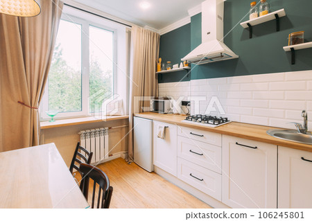 Modern Bright Kitchen In Scandinavian Stylish. Family Apartment With Dinner Table And Chairs. Idea For Home Design. Light Colors Of Design. Stylish Apartment Interior Of Kitchen, Kitchen Equipment 106245801