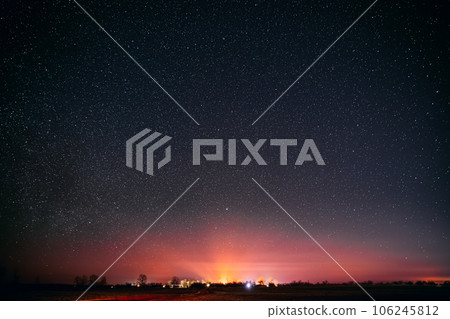 Amazing Sunset Sunrise Morning Sky With Bright Glowing Night Stars. Morning Summer Time. Sunset Sun Shining Above Landscape. Warm Yellow And Orange Colors. Dark Ground Amazing Sunset Sunrise Morning Sky With Bright Glowing Night Stars. Morning Summer Time. Sunset Sun Shining Above Landscape. Warm Yellow And Orange Colors. Dark Ground 106245812