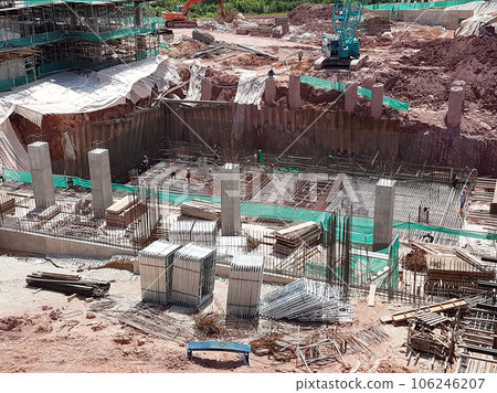 KUALA LUMPUR, MALAYSIA - OCTOBER 5, 2022: Building foundation construction work is being carried out briskly at the construction site. Heavy machinery and construction workers are busy doing work. KUALA LUMPUR, MALAYSIA - OCTOBER 5, 2022: Building foundation construction work is being carried out briskly at the construction site. Heavy machinery and construction workers are busy doing work. 106246207