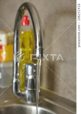 water pouring from a faucet tap slow motion water pouring from a faucet tap slow motion 106251418