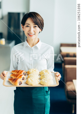 Middle-aged woman working in a bakery 106251898