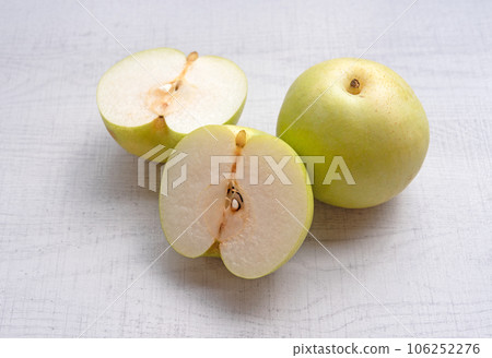Japanese pear on wooden background. Sweet japanese fruit in autumn. Japanese pear on wooden background. Sweet japanese fruit in autumn. 106252276