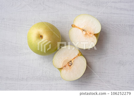 Japanese pear on wooden background. Sweet japanese fruit in autumn. Japanese pear on wooden background. Sweet japanese fruit in autumn. 106252279