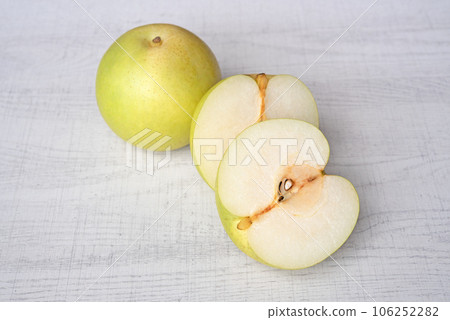 Japanese pear on wooden background. Sweet japanese fruit in autumn. Japanese pear on wooden background. Sweet japanese fruit in autumn. 106252282