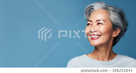 Middle-aged Asian woman with a short gray hairdo looking at copy space. Middle-aged Asian woman with a short gray hairdo looking at copy space. 106252641