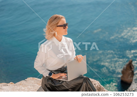 Business woman on nature in white shirt and black skirt. She wor 106253273