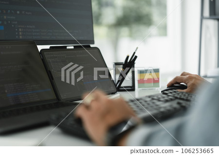 Developer programmer checking code on multiple monitor while programming to developing web and apps Developer programmer checking code on multiple monitor while programming to developing web and apps 106253665