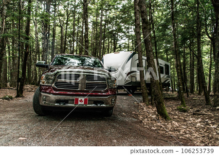 A pickup truck towing a camper RV trailer during summer time at Kejimkujik National Park Nova Scotia Canada A pickup truck towing a camper RV trailer during summer time at Kejimkujik National Park Nova Scotia Canada 106253739