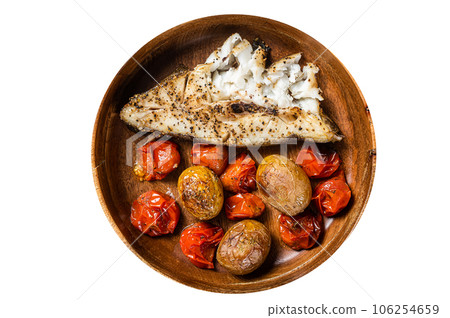 Baked halibut fish with roasted tomato and potato in wooden plate. High quality Isolate, white background. 106254659