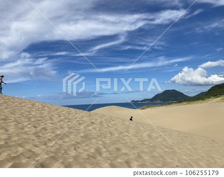 Blue summer sky, sand dunes and green mountains 106255179