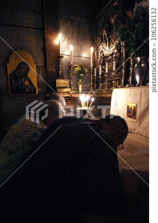 Pilgrims pray at the tomb of Jesus in the Church of the Holy Sepulchre, traditional site of the crucifixion, burial, and resurrection of Jesus, Jerusalem 106256132