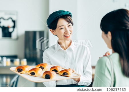 Bakery staff serving customers 106257585