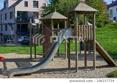 Children Playground with Modern Slide, Rope Net Bridge, Climbing Swings, Climbers. Empty Wooden Playground made of Eco Materials - Wooden Tree trunk. Colorful playground on yard in the park. Children Children Playground with Modern Slide, Rope Net Bridge, Climbing Swings, Climbers. Empty Wooden Playground made of Eco Materials - Wooden Tree trunk. Colorful playground on yard in the park. Children 106257734